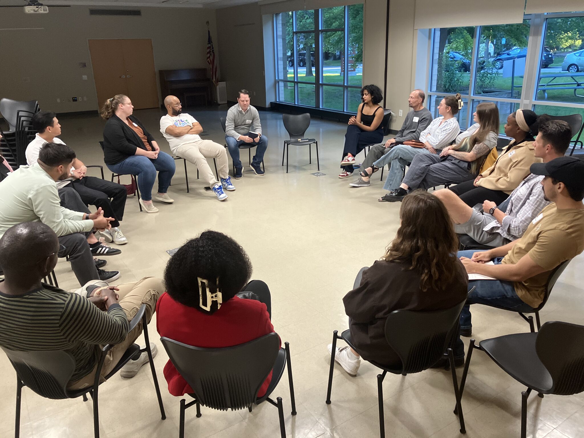 Rotaract Club of Milwaukee members in a discussion circle at a community event
