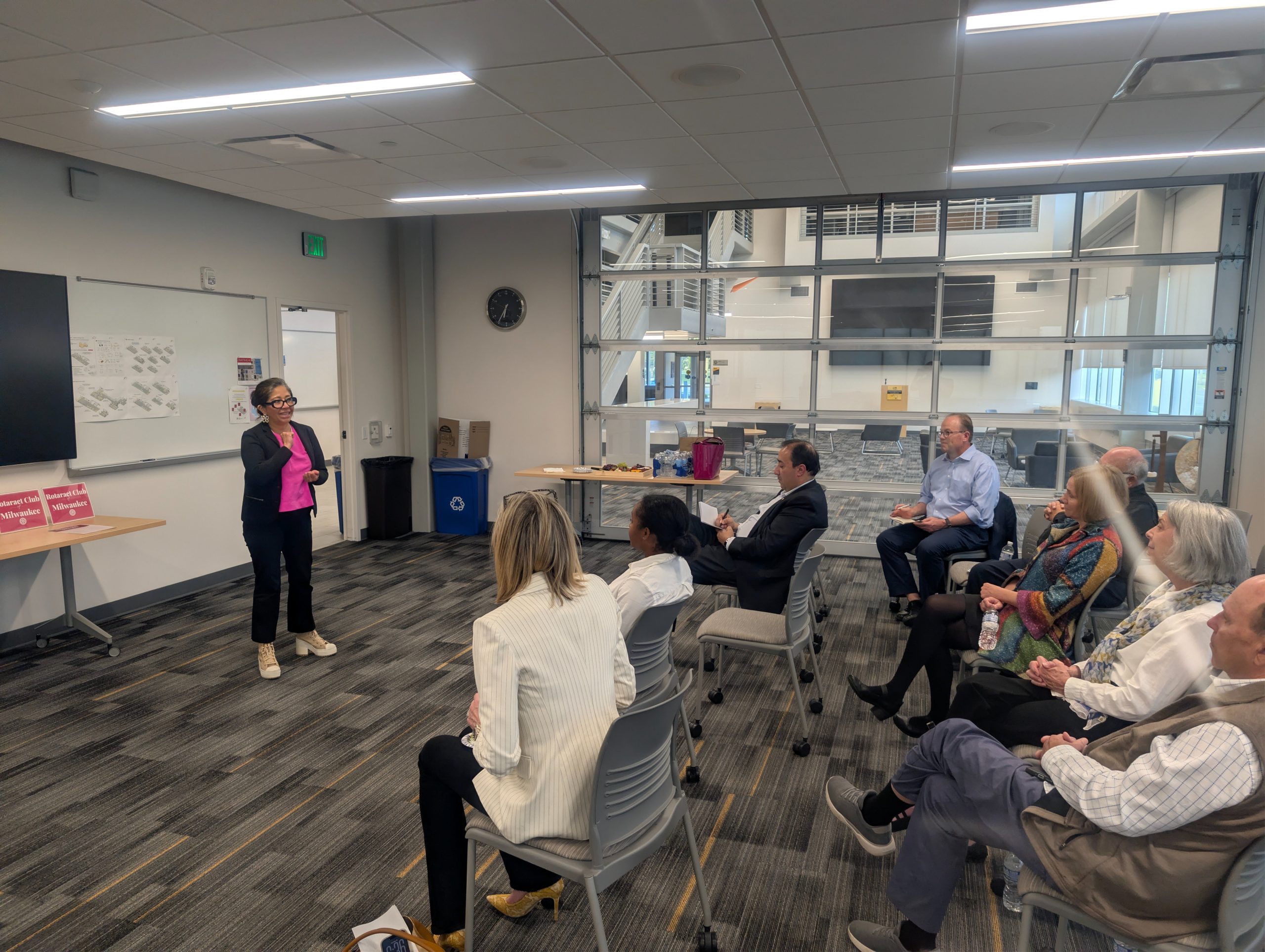 A guest speaker addressing Rotaract Club of Milwaukee members during a club meeting