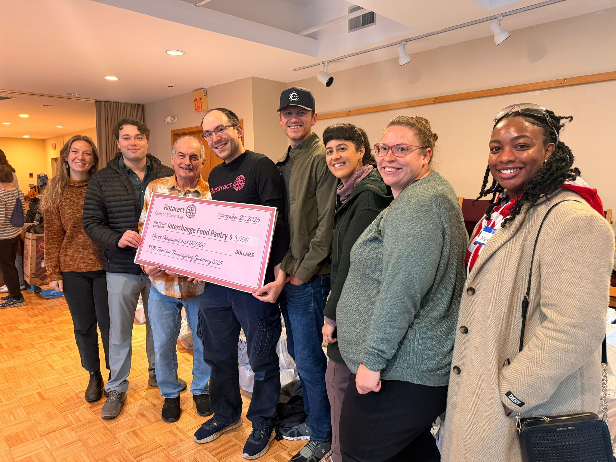 Rotaract Club of Milwaukee members presenting a donation check to the Interchange Food Pantry