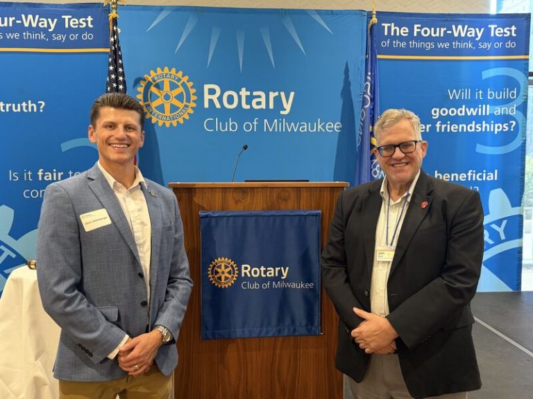 Rotaract Club of Milwaukee members with the Rotary Club of Milwaukee Four-Way Test banners