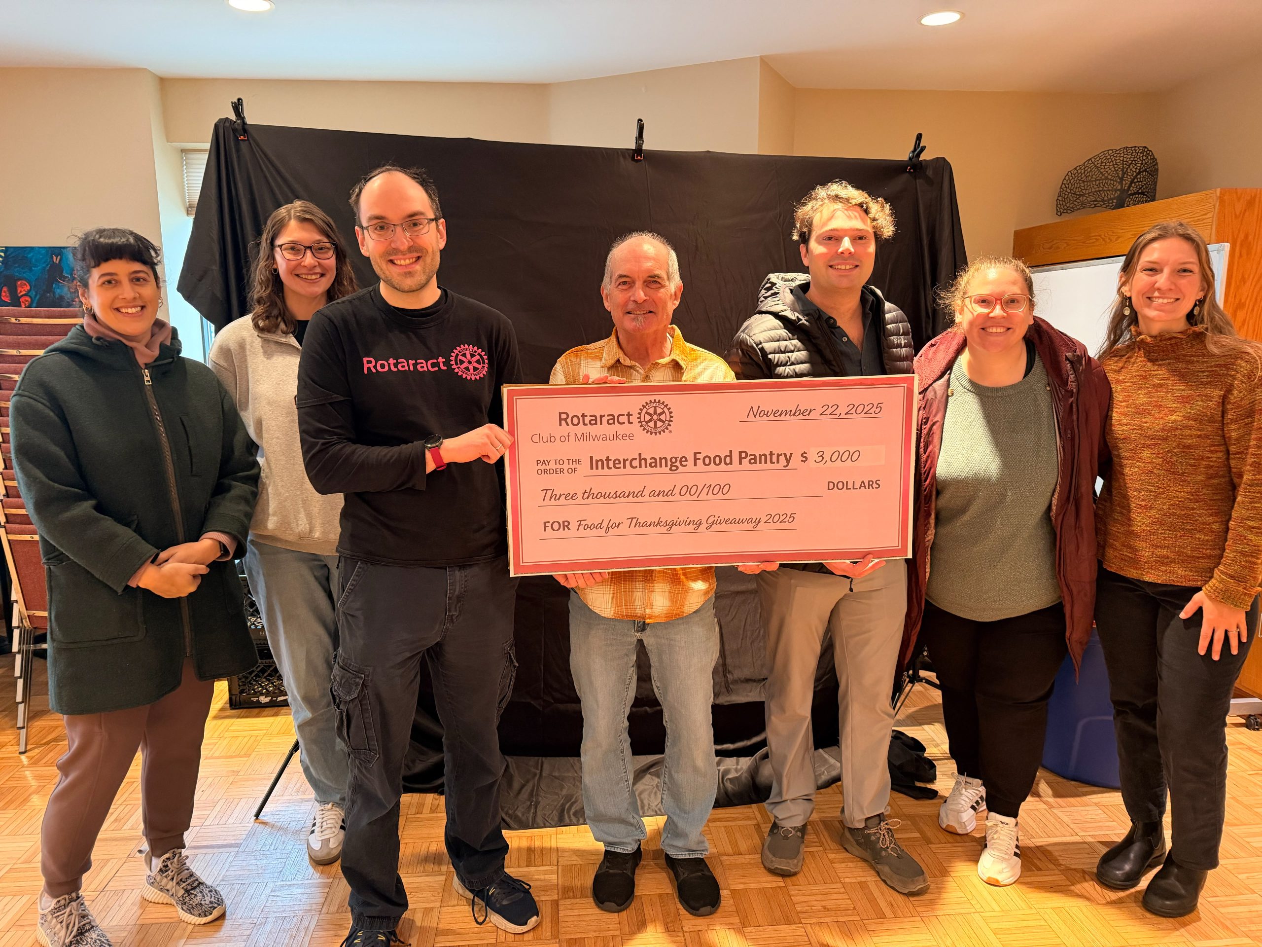 Rotaract Club of Milwaukee members presenting a three thousand dollar check to Interchange Food Pantry
