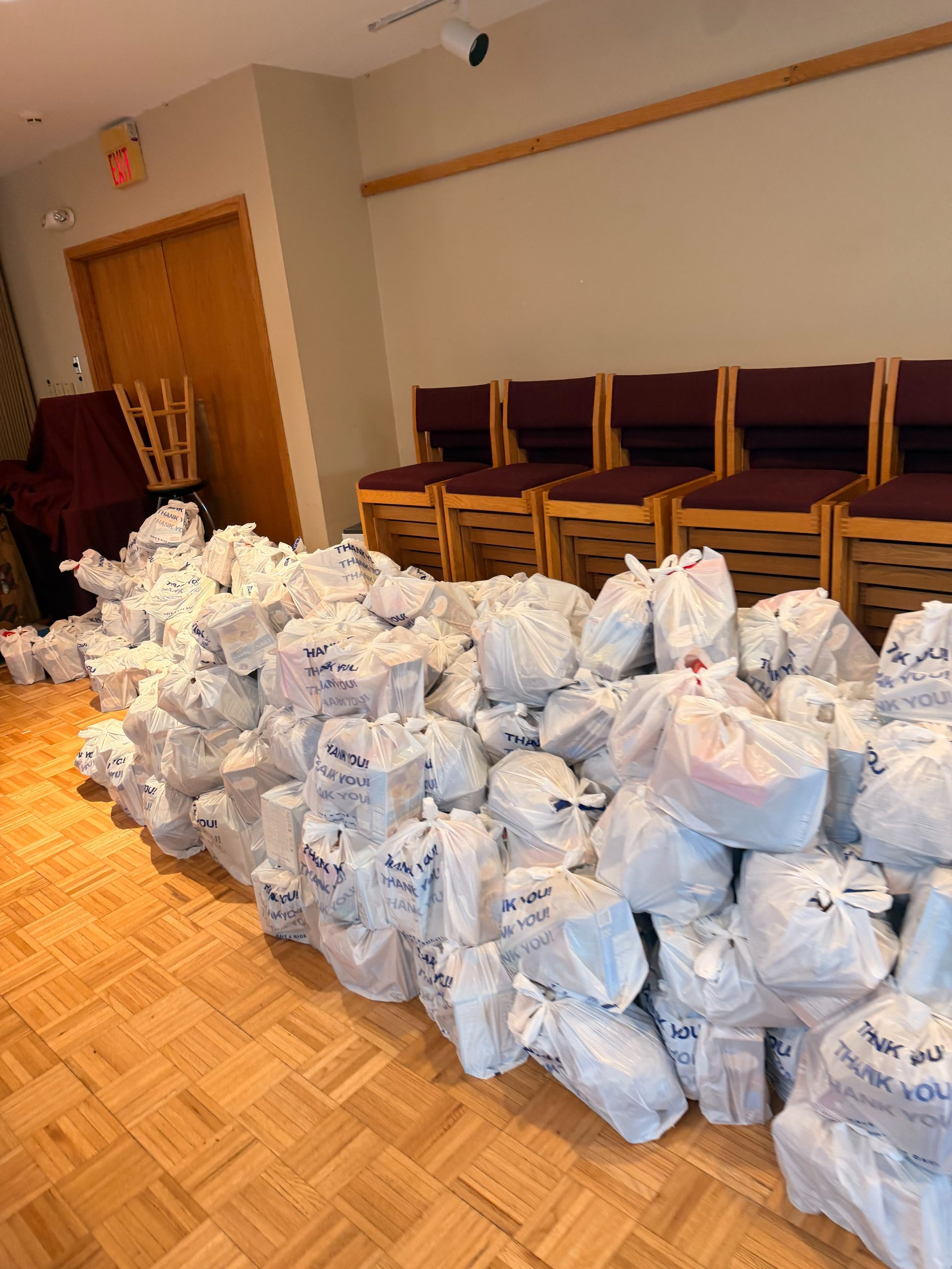 Bags of donated food ready for distribution at the Thanksgiving Giveaway