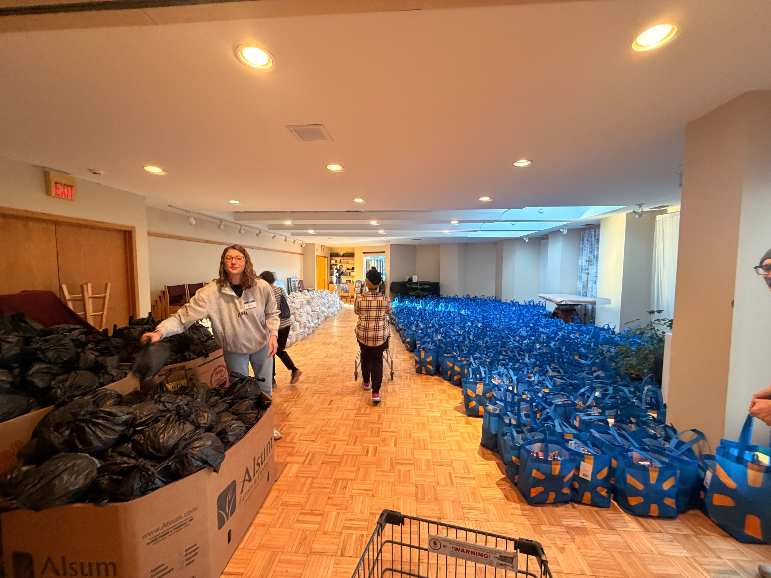 Volunteers sorting bags of donated food for the Thanksgiving Giveaway